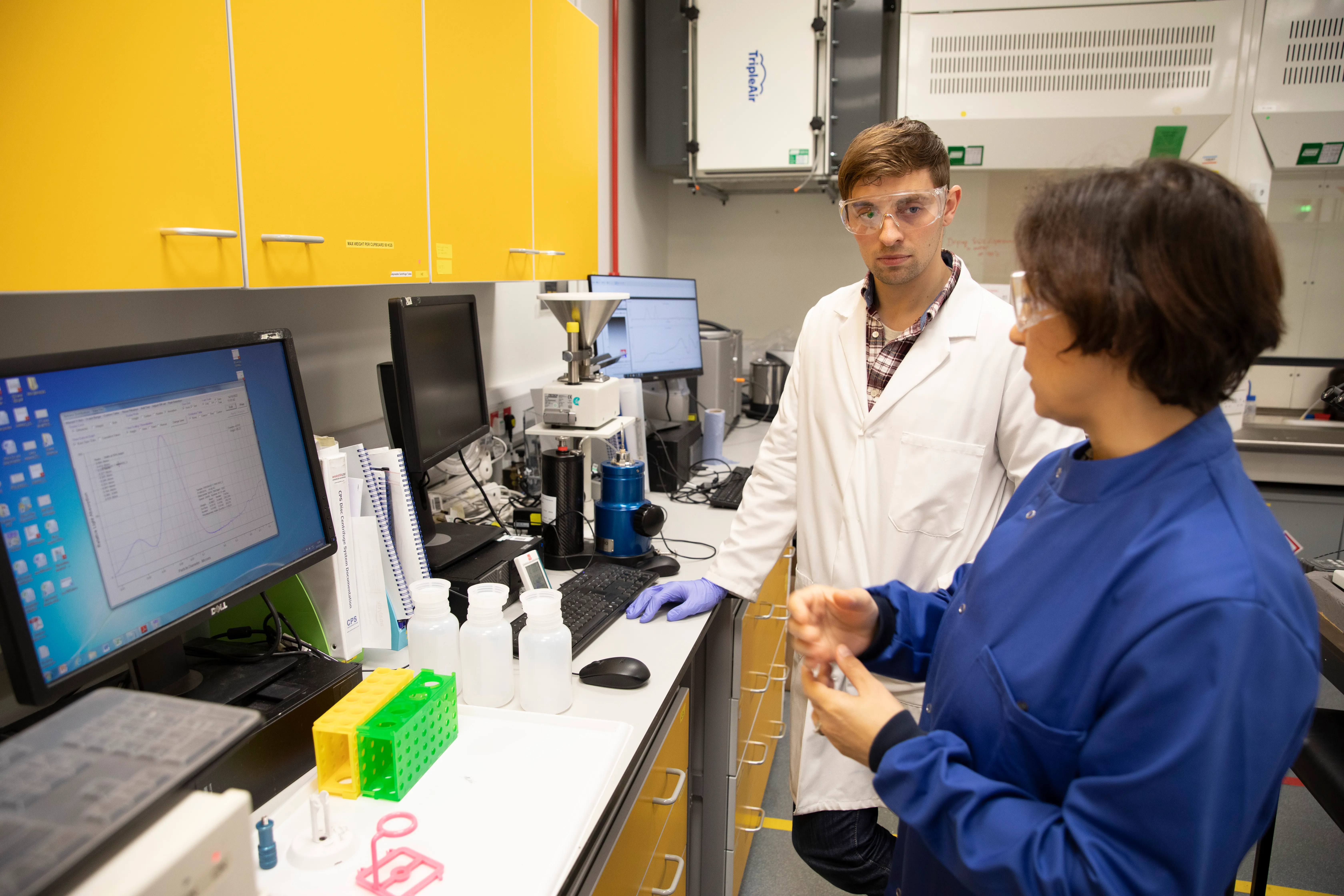 Researchers carrying out particle analysis in liquid in a laboratory