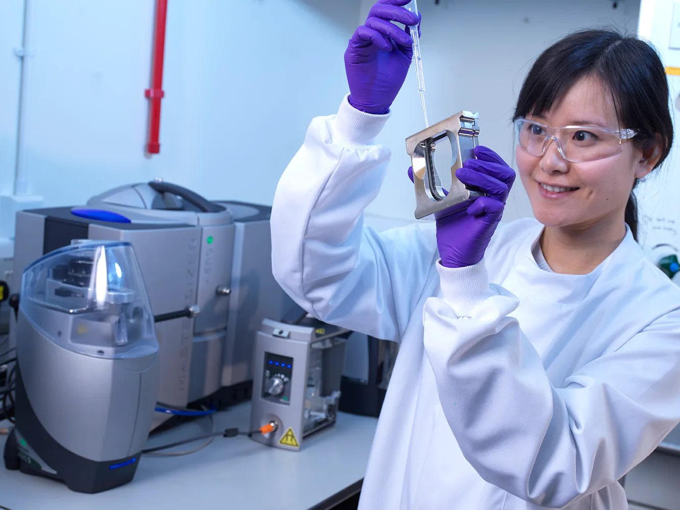 A researcher analysing particles in a liquid sample